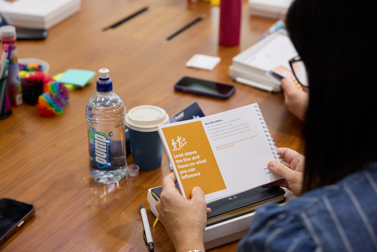 A leader working through the FirstUp Leadership Programme workbook